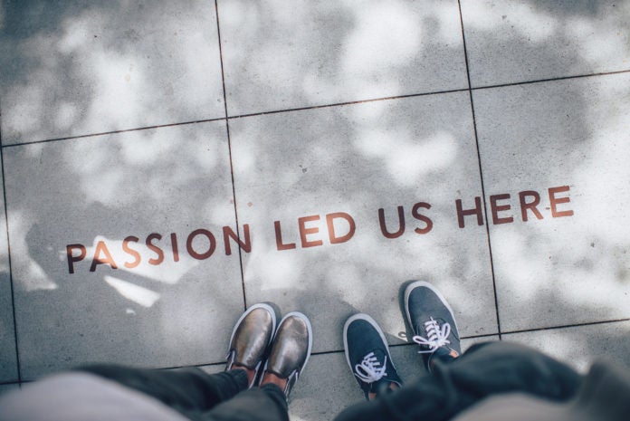 Feet on sidewalk, with words "passion led us here"